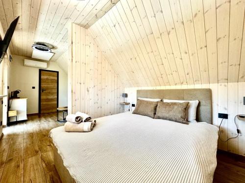 a bedroom with a large bed with a teddy bear on it at G17-1 Palanga in Palanga