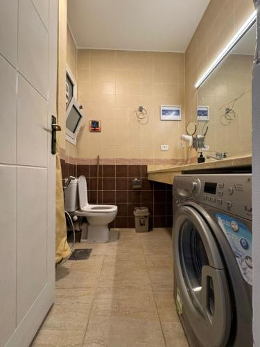 a bathroom with a washing machine and a toilet at Florence Chalet in Marina Wadi Degla Ain Sokhna - Ground floor with 360 Sqm with Private Garden in Ain Sokhna