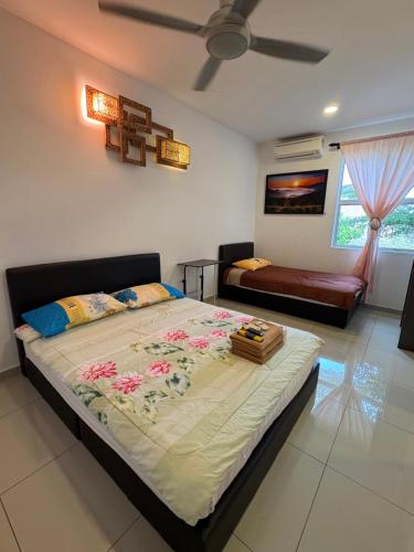 a bedroom with a large bed and a ceiling fan at Art Villa in Alor Setar