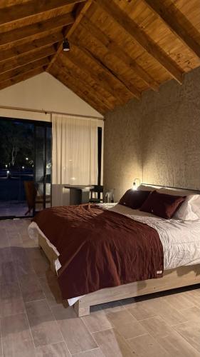 a bedroom with a large bed and a table at Villa Vadori Suites in Falda del Carmen