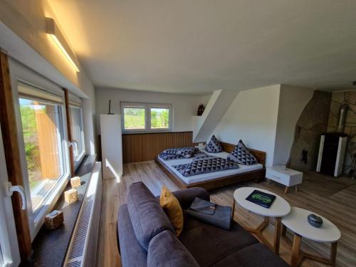 a living room with a couch and a bed at Ferienwohnung Stützengrün in Stützengrün