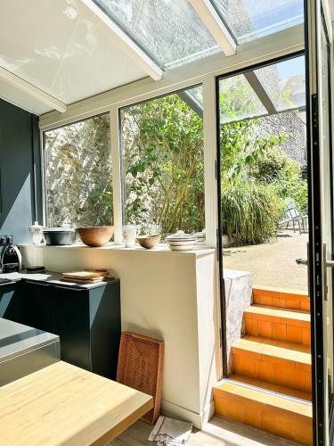a kitchen with a window and a table and a counter at Les Soupières in Fécamp