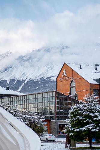 a church in front of a snow covered mountain at Hotel Albatros in Ushuaia