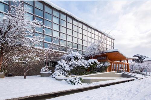 an office building with snow on the ground at Hotel Albatros in Ushuaia