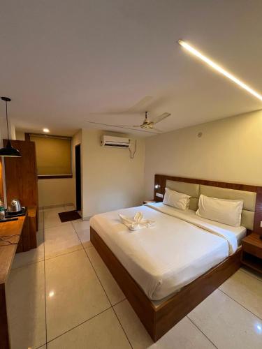 a bedroom with a large white bed in a room at Hotel LIORA GRAND in Bangalore