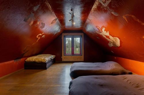 an attic room with two beds and a window at Kussharoko Artemina Deer in Teshikaga