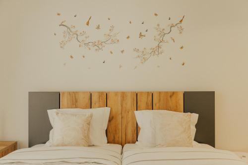 a bedroom with two beds and a wall with butterflies at Gerês Thermal Escape in Geres