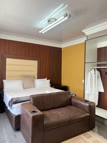 a bedroom with a bed and a couch at Kariebi Guest House in Bethlehem