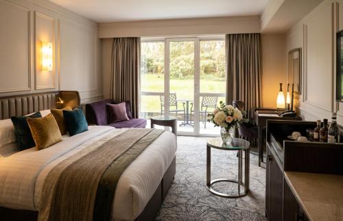 a hotel room with a bed and a balcony at Maryborough Hotel & Spa in Cork