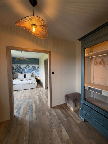 a bedroom with a bed and a television in it at La rose Poncet in Gardegan-et-Tourtirac