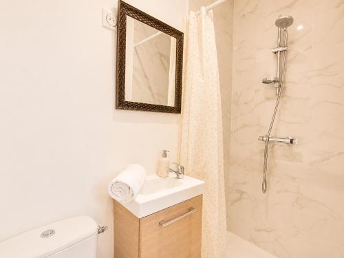 a white bathroom with a sink and a shower at Road Stop Studio - Paris - Disney- Train Station in Chelles