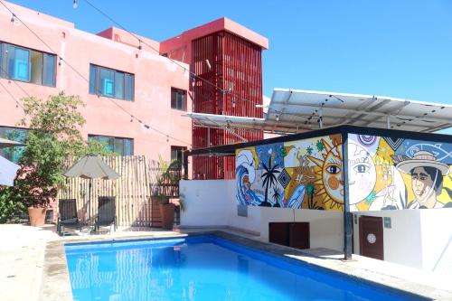 a swimming pool with a mural on the side of a building at Sayulita Boutique Suites - Pool Access, Kitchen, Walk to Beach in Sayulita