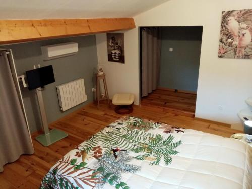 a bedroom with a large white bed in a room at Laroclya in Lilhac