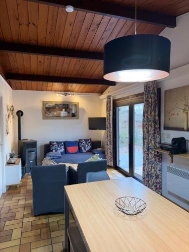 a kitchen and living room with a couch and a table at Cabana 16 in Petit Mesnil