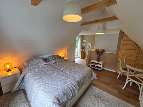 a bedroom with a bed and a table and chairs at Ferienwohnungen Stilschön in Warnemünde