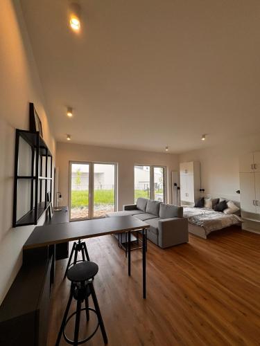 a large living room with a table and a couch at Apartmán v komplexu Meridiem in Komárov