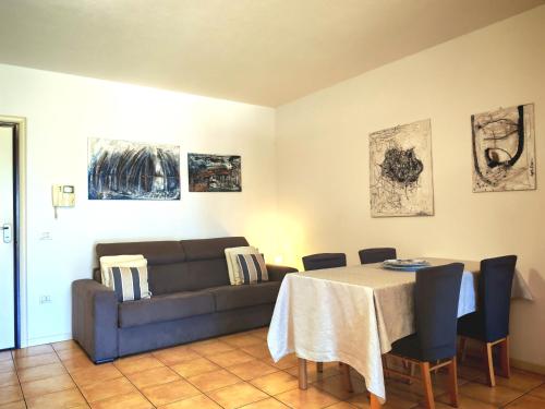 a living room with a couch and a table at VistaMare Bluemar - Garden & Sea in Cattolica