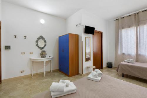 a living room with a bed and a blue cabinet at Demetra Malophoros in Marinella di Selinunte