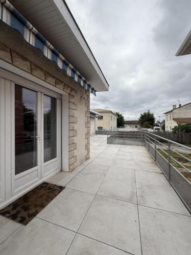 a walkway leading to a house with a glass door at Chambre Studio privé in Villenave-dʼOrnon