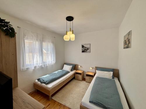 a bedroom with two beds and a window at ThePAGHouse in Pag