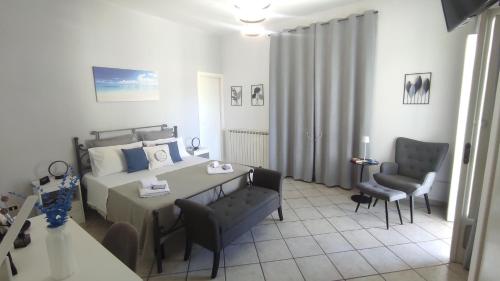 a bedroom with a bed and a table and chairs at CAPERCIA home in Forio d'Ischia