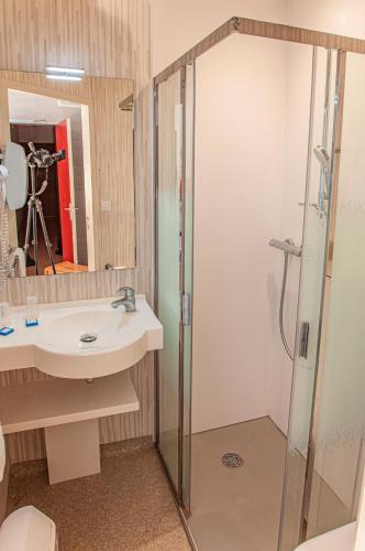 a bathroom with a sink and a shower at Village Vacances L'Oustal in Salles-la-Source