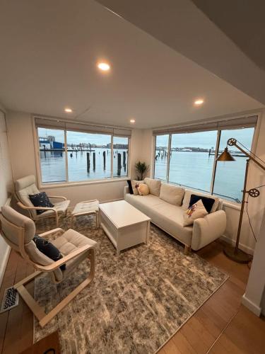 a living room with a couch and a table at Endless Summer Oceanside Views in Boston