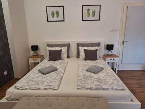 a large white bed with two pillows on it at Eurovelo6 Stop in Solt