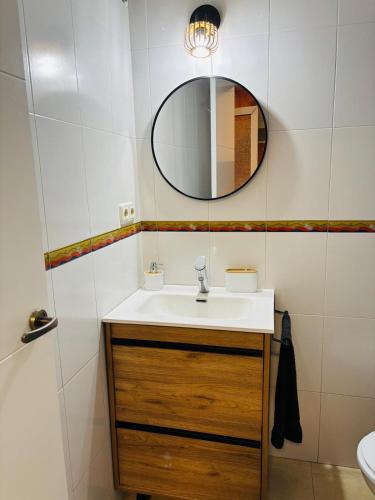 a bathroom with a sink and a mirror at Ca Isaak in Denia
