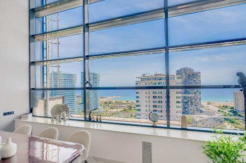 a room with a large window with a view of the city at Penthouse Duplex with TOP Views! in Barcelona