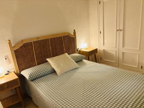 a bedroom with a bed with a pillow on it at Ca Isaak in Denia