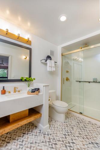 a bathroom with a sink and a toilet and a shower at All-Movie Hotel in Peachtree City