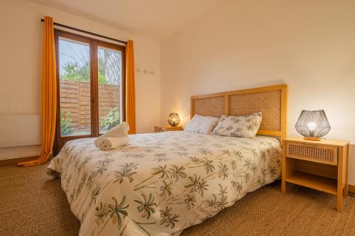 a bedroom with a large bed and a window at Villa Paradis - Grande demeure familiale proche Puy-du-Foυ in Cholet
