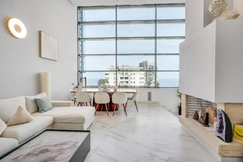 a living room with a white couch and a table at Penthouse Duplex with TOP Views! in Barcelona