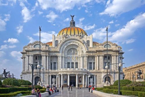 a large white building with a gold dome at Hotel Florida, Centro Histórico in Mexico City