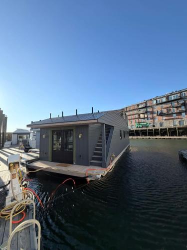 a small house on a boat in the water at The Wave in Boston