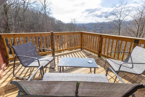 a deck with two chairs and a table on it at A Red Chalet in Newland