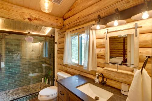 a log cabin bathroom with a sink and a toilet at Durango Mountain Escape w/ Stunning Views in Durango
