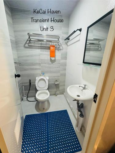 a bathroom with a toilet and a sink at Kecai Haven Transient House in Digos