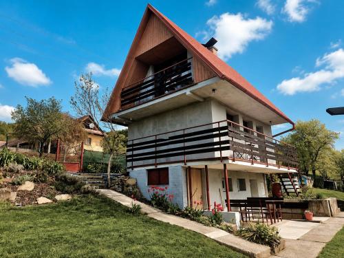 a house with a gambrel roof on top of it at Chatička Lukov in Lukov