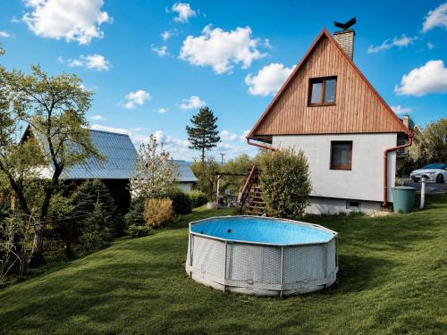 a house and a pool in front of a house at Chatička Lukov in Lukov