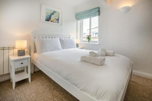 a bedroom with a large white bed with a window at 1 Bed in St. Ives oc-pc466a in St Ives