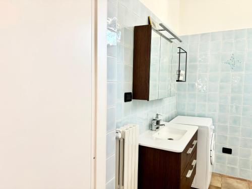 a bathroom with a white sink and blue tiles at Casetta Rocca in Rocca San Giovanni