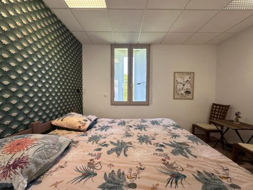 a bedroom with a bed and a window at Bastide en Margeride in Châteauneuf-de-Randon