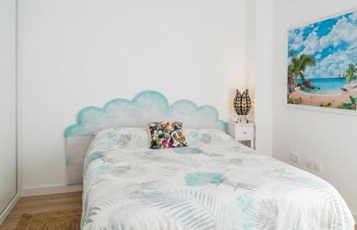a bedroom with a bed with a blue headboard at Aguas de Mar in Castillo de BaÃ±os