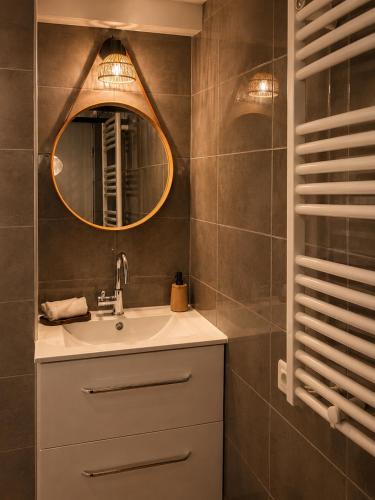 a bathroom with a sink and a mirror at Spa et sauna - Loft Cataleya in Belfort