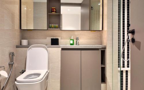 a bathroom with a toilet and a sink and a shower at IKON SUITE's E A T O N KLCC in Kuala Lumpur