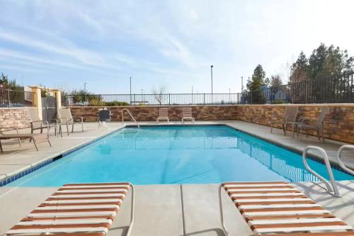 a large swimming pool with lounge chairs at University Hotel Davis Area by IHG in Dixon