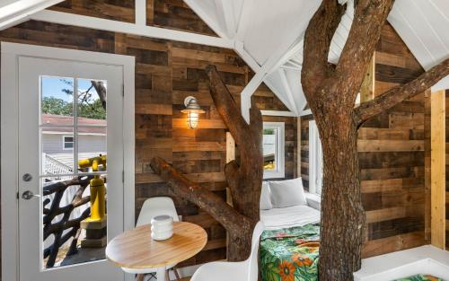 a tree house with a bedroom and a table at Tickle Me Tides in Inlet Beach