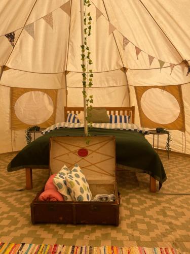 a bed in a tent with a bed in a box at Nine Acres, Hot Tub, peaceful in Brackley
